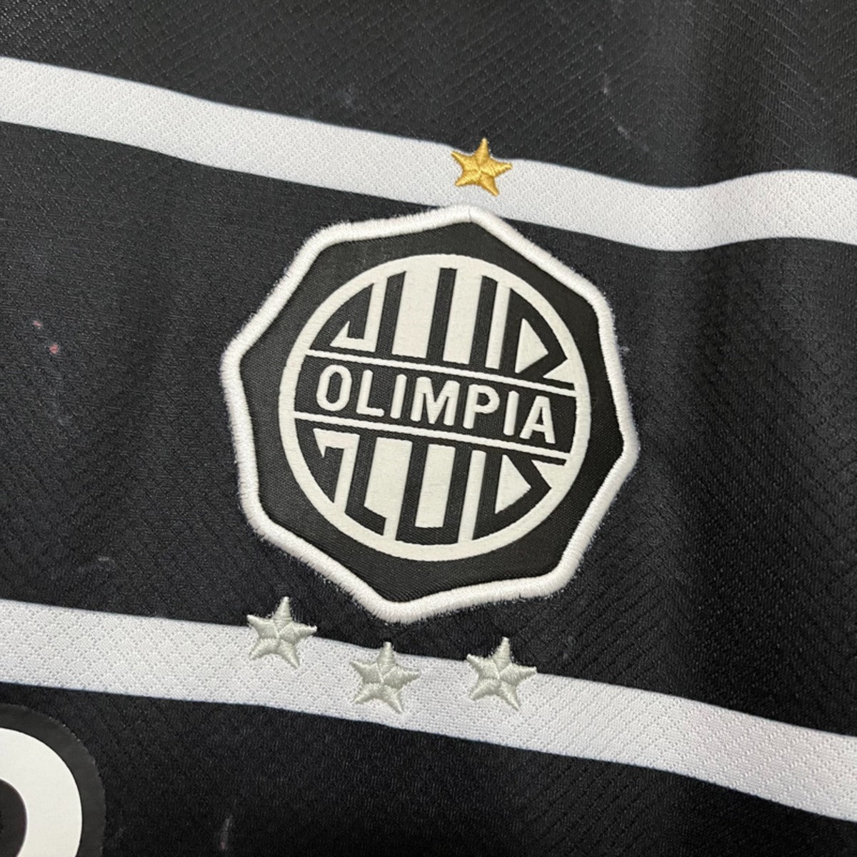 Camisola Olimpia Asuncion 2025-26 Alternativa Preta Versão Adepto